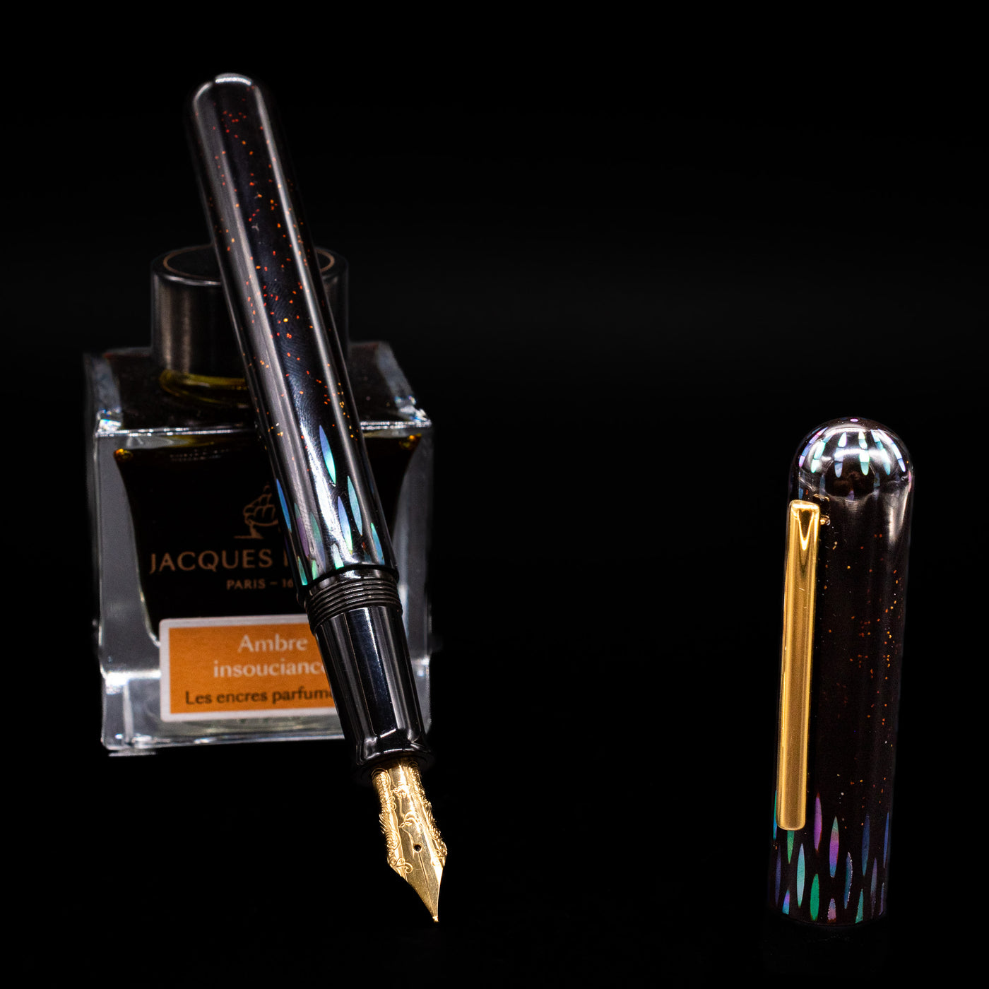 Nahvalur Ikkaku Urushi Fountain Pen - Ye Yu leaning on an ink bottle uncapped showcasing the detailing on the nib.