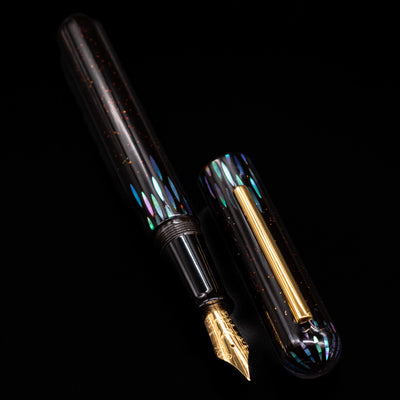 A full view of the Nahvalur Ikkaku Urushi Fountain Pen - Ye Yu uncapped, with its cap laying next to the pen. 