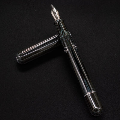 Close-up of Nahvalur Leviathan umber ebonite texture – dark green-black resin with natural swirling pattern