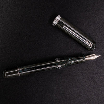 Overhead view of Nahvalur Leviathan fountain pen uncapped – umber ebonite body, chrome trim, and stainless steel nib