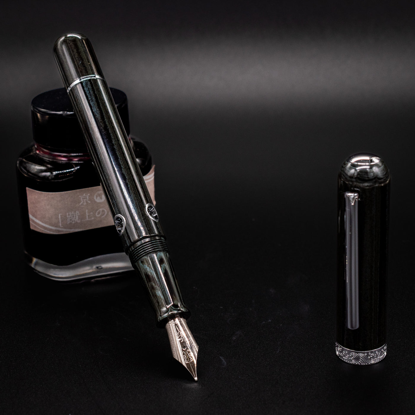 Nahvalur Leviathan fountain pen uncapped – stainless steel nib and green-black umber ebonite body with piston filling system