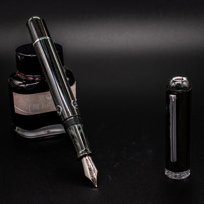 Nahvalur Leviathan fountain pen uncapped – stainless steel nib and green-black umber ebonite body with piston filling system