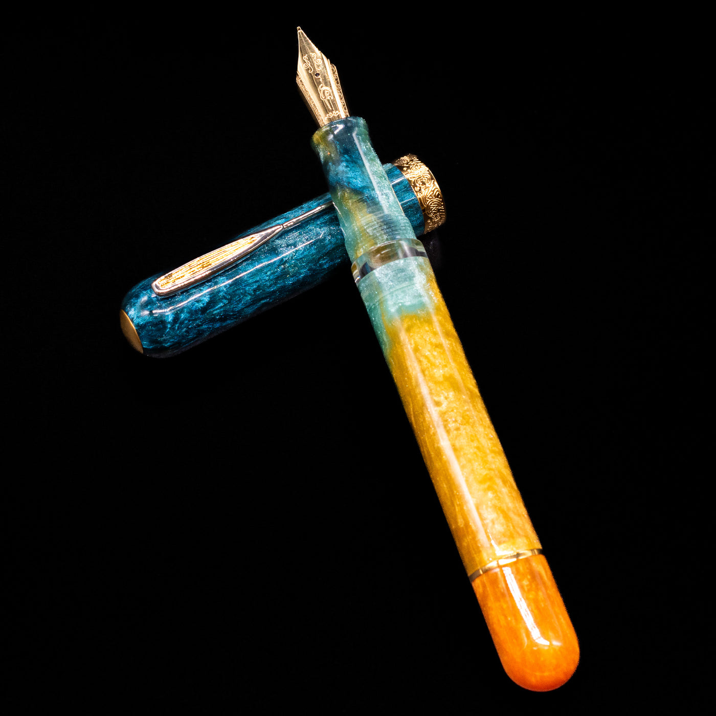 Nahvalur Voyage Fountain Pen - Hawaii laying on top of its cap in a crossed position showing full view of the entire uncapped pen.