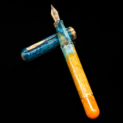 Nahvalur Voyage Fountain Pen - Hawaii laying on top of its cap in a crossed position showing full view of the entire uncapped pen.