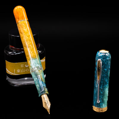 Nahvalur Voyage Fountain Pen - Hawaii leaning on an ink bottle uncapped showcasing the detailing on the nib.