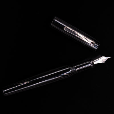 An overhead view of the Nakaya Piccola Long Fountain Pen - Kuro Tame uncapped.
