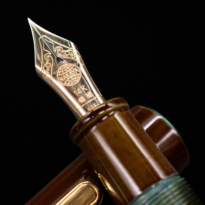 A macro shot of the nib with its intricate detailing and logo engraving for the Nakaya Portable Writer Fountain Pen - Heki Tamenuri.