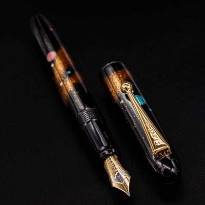 Side angle of pen with cap on – Highlighting the deep black urushi lacquer and iridescent details reflecting starlit skies.
