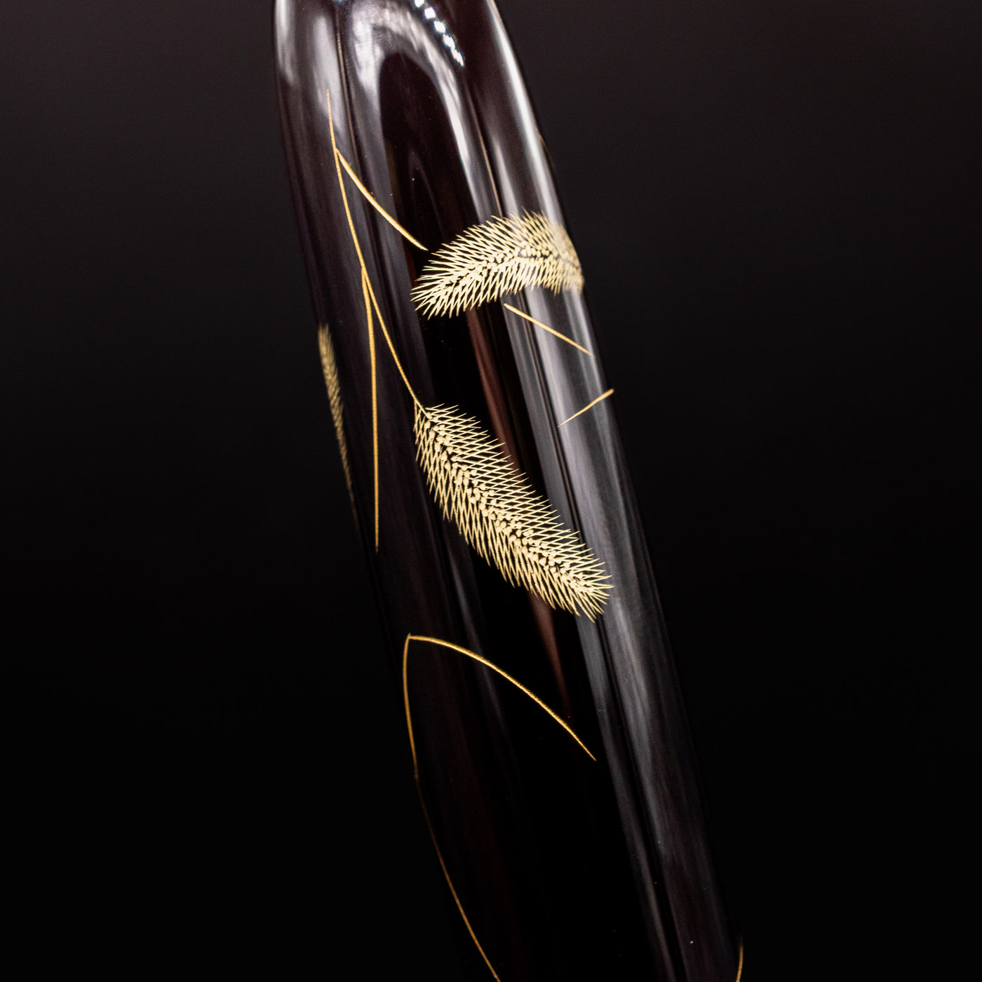 Close-up of cattail plant design – Featuring intricate chinkin engraving of delicate cattail plants, symbolizing nature’s tranquility.