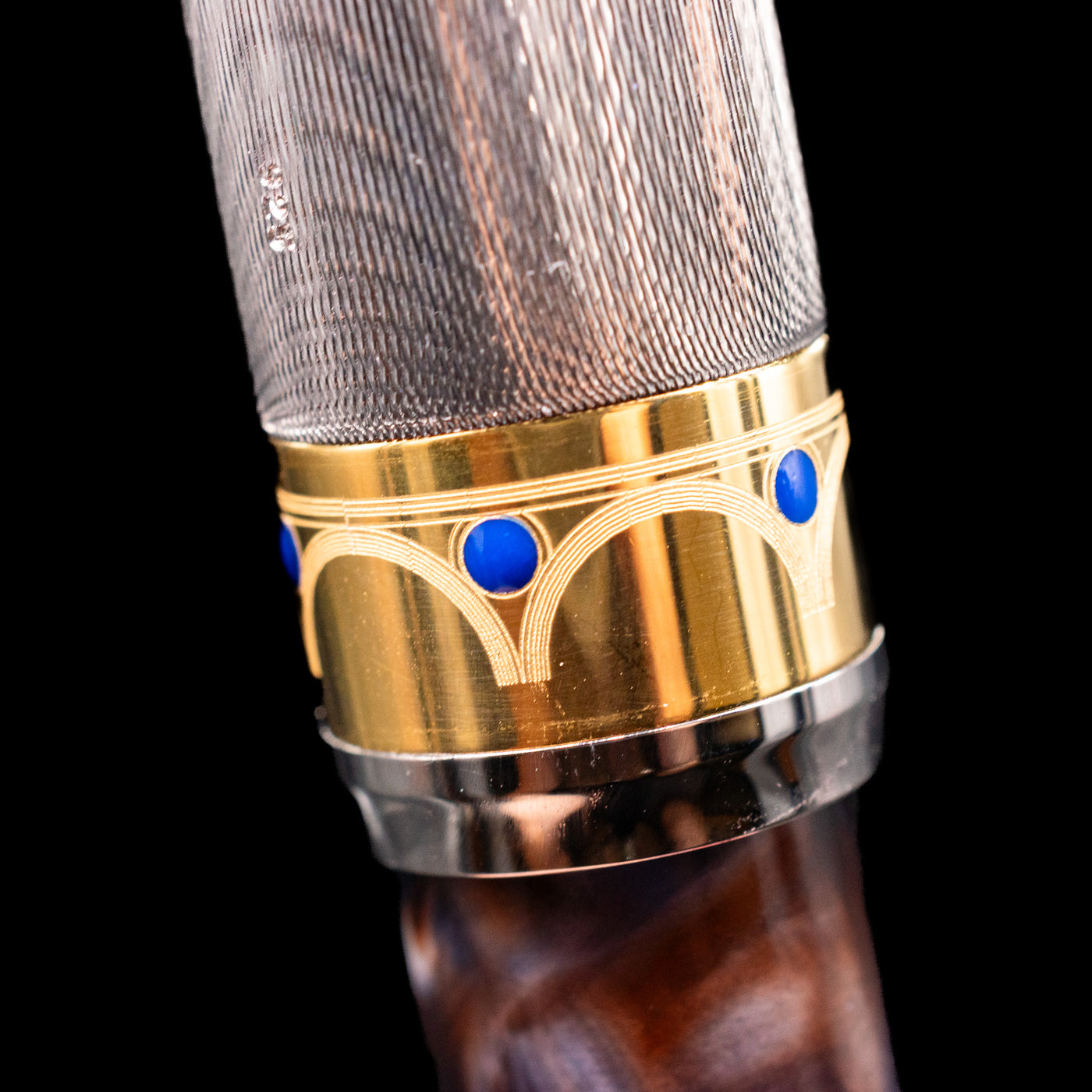 Macro shot of the center band detailing on the OMAS Bologna Fountain Pen - Galassia Argento.