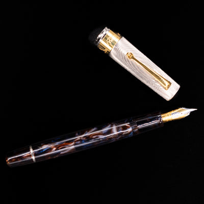 An overhead view of the OMAS Bologna Fountain Pen - Galassia Argento uncapped.