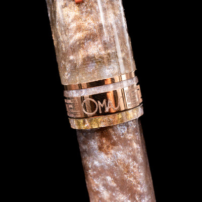 Detail shot of the center band showcasing the logo on the OMAS Ogiva Cocktail Series Fountain Pen - Espresso Martini.
