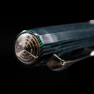 Zoomed-in view of the top of the cap with the finial on the OMAS Paragon Fountain Pen - Arco Verde.