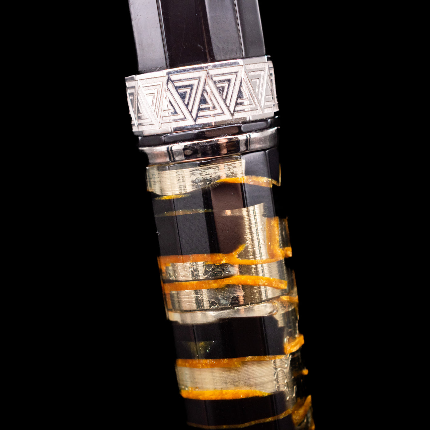 A macro shot of the lucen material and center band on the OMAS Paragon Fountain Pen - Black Lucen.