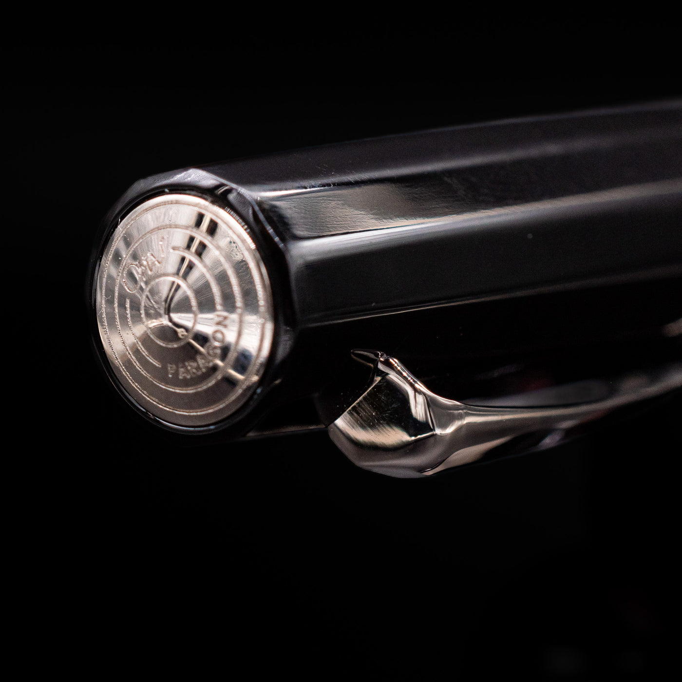 Zoomed-in view of the top of the cap with the finial on the OMAS Paragon Fountain Pen - Black Lucen.