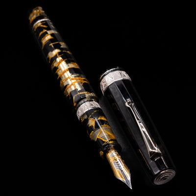 A full view of the OMAS Paragon Fountain Pen - Black Lucen uncapped, with its cap laying next to the pen. 