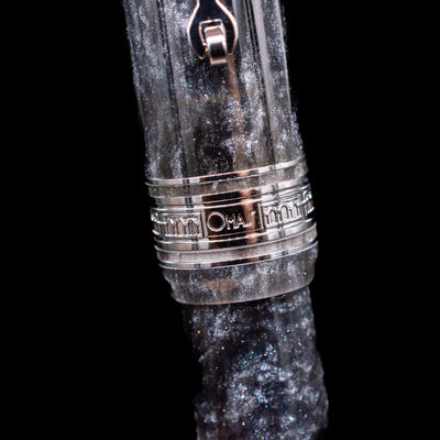 A zoomed in shot of the center band with the logo of the Omas Bologna Fountain Pen - Bright Grey.