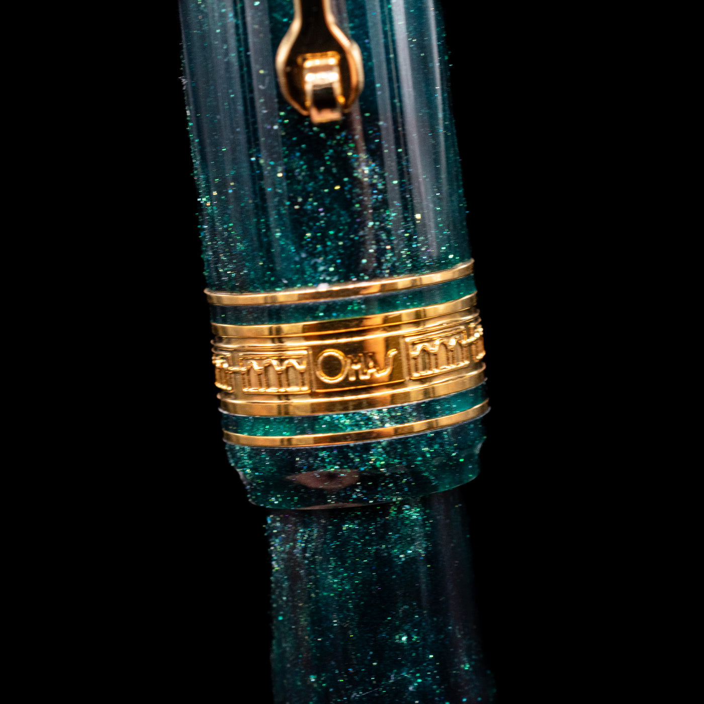 A macro shot of the center band and logo on the Omas Bologna Fountain Pen - Elegant Emerald.