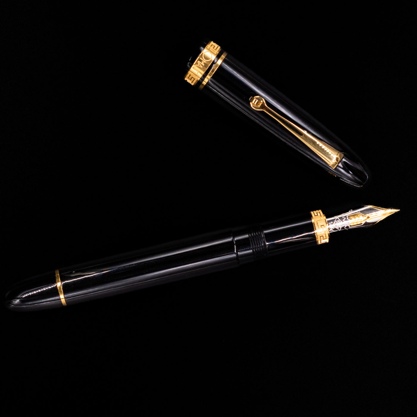 An overhead view of the Omas Ogiva Fountain Pen - Nera Gold uncapped.