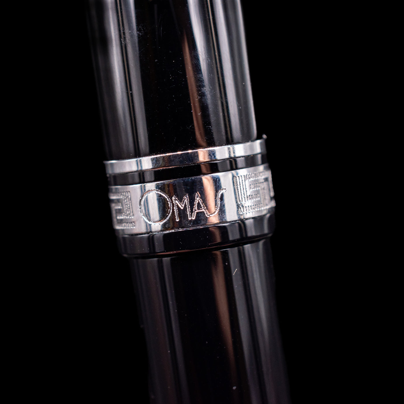 A macro shot of the center band with the logo on the Omas Ogiva Fountain Pen - Nera Silver.