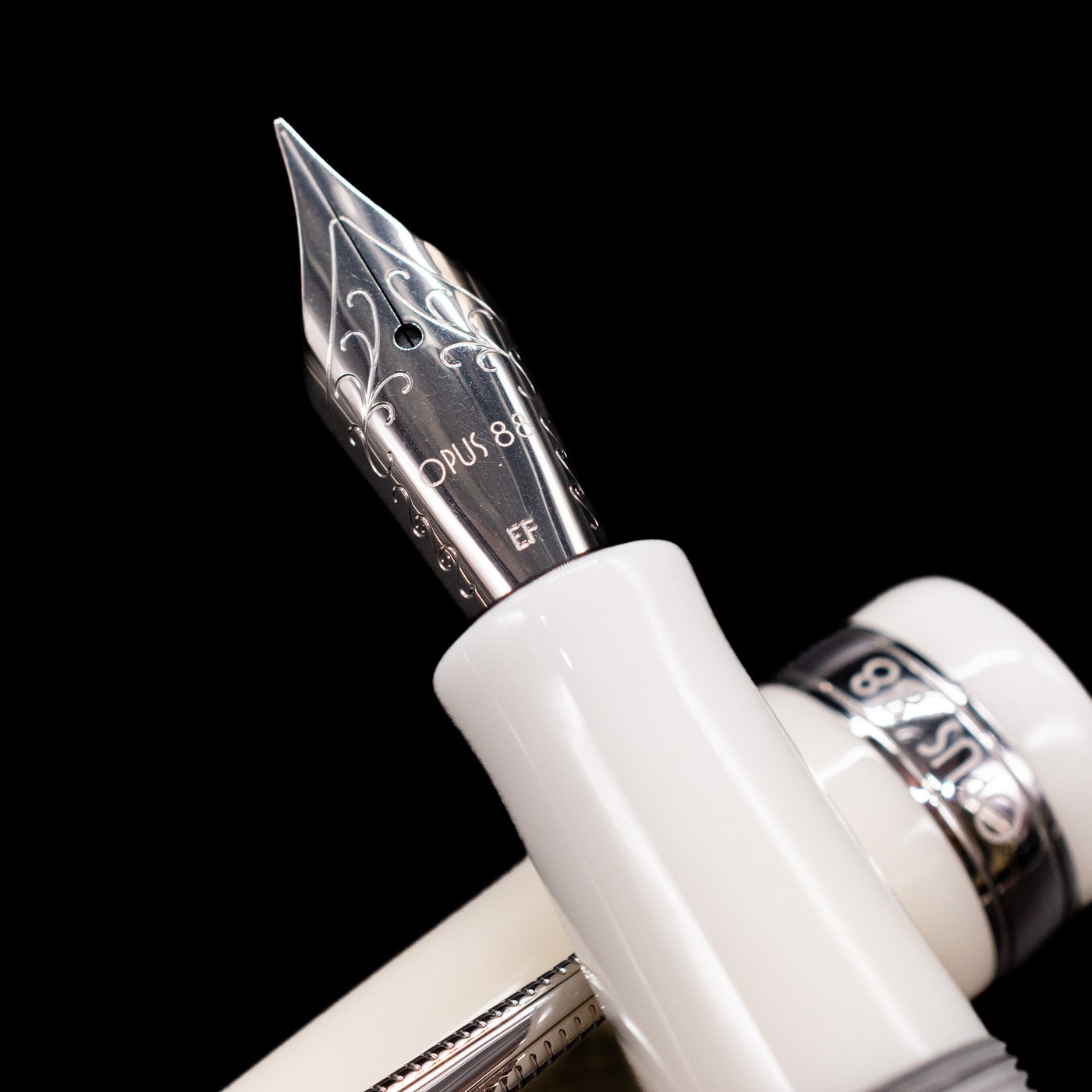  A macro shot of the nib with its intricate detailing and logo engraving for the Opus 88 Jazz Solid White Fountain Pen - Preowned.