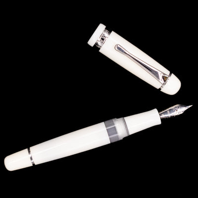An overhead view of the Opus 88 Jazz Solid White Fountain Pen - Preowned uncapped.