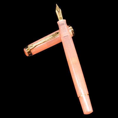 Pelikan Classic M200 Fountain Pen - Apricot Achat laying on top of its cap in a crossed position showing full view of the entire uncapped pen.