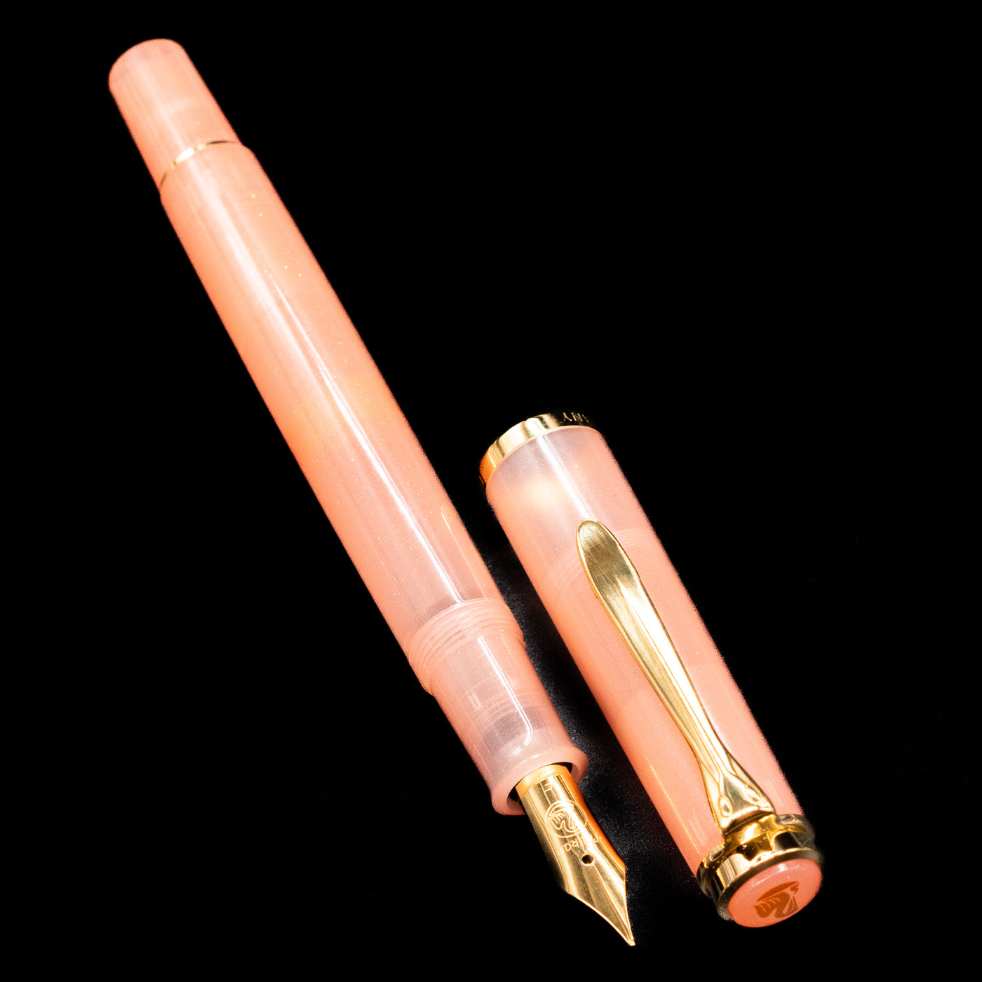 A full view of the Pelikan Classic M200 Fountain Pen - Apricot Achat uncapped, with its cap laying next to the pen. 