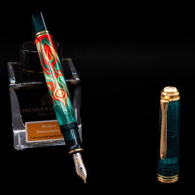 Pelikan Souveran M605 Art Collection Fountain Pen - Rudi Rother leaning on an ink bottle uncapped showcasing the detailing on the nib.