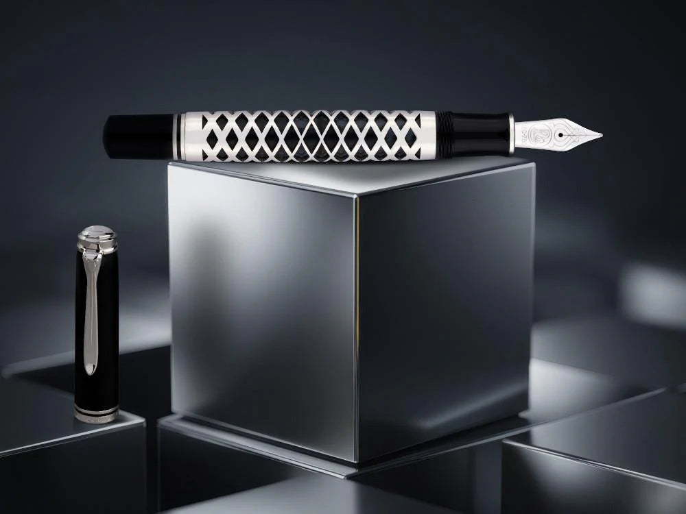 Fountain pen with decorative cap on a reflective surface