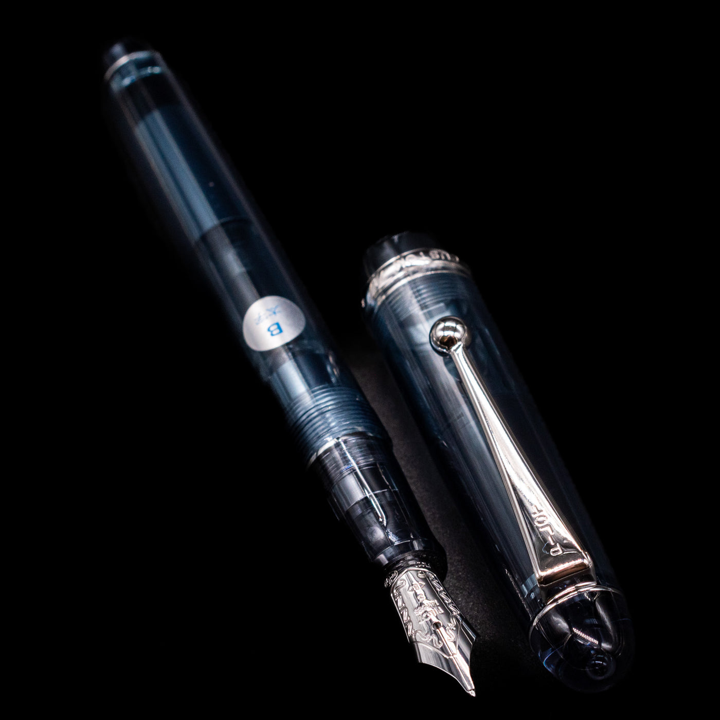 A full view of the Pilot Custom 74 Fountain Pen - Blue Stone uncapped, with its cap laying next to the pen. 