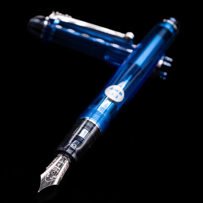 Pilot Custom 74 Fountain Pen - Blue laying across its own cap, crossed, with a focus on the nib.