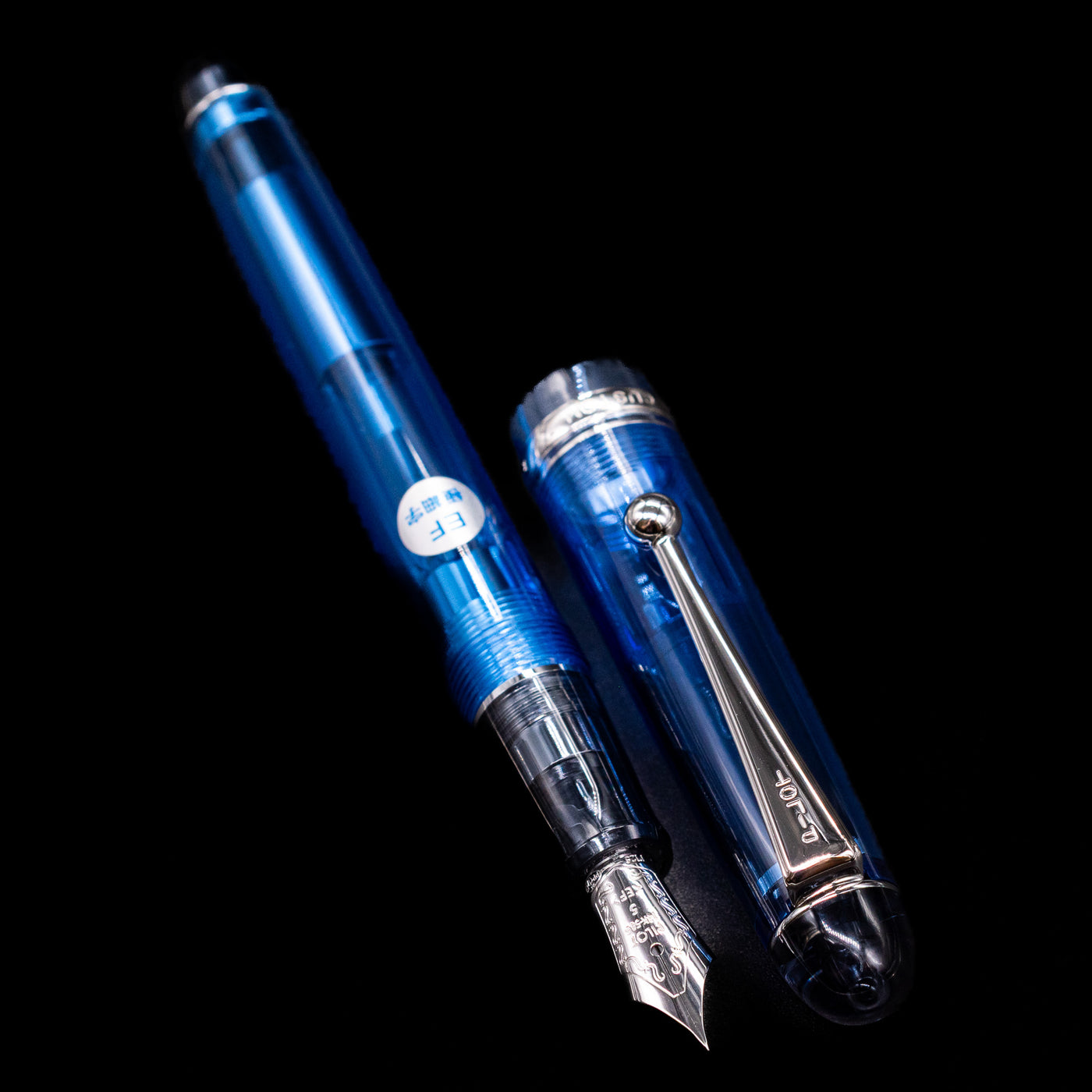 A full view of the Pilot Custom 74 Fountain Pen - Blue uncapped, with its cap laying next to the pen. 