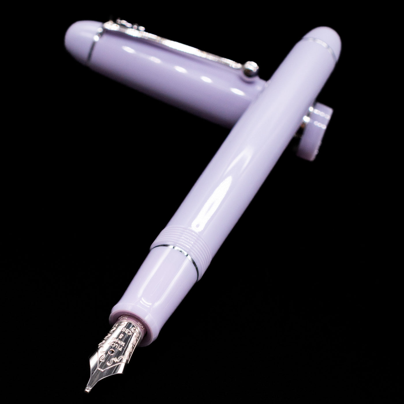 Pilot Custom 74 Fountain Pen - Lavender Fog laying across its own cap, crossed, with a focus on the nib.