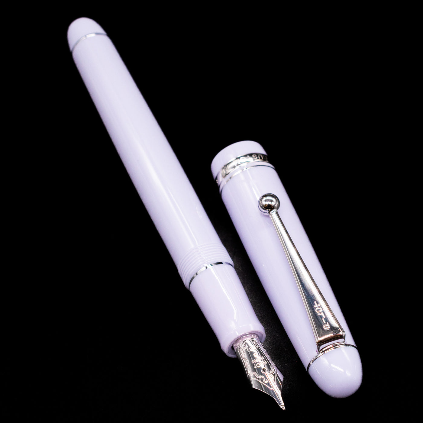 A full view of the Pilot Custom 74 Fountain Pen - Lavender Fog uncapped, with its cap laying next to the pen. 