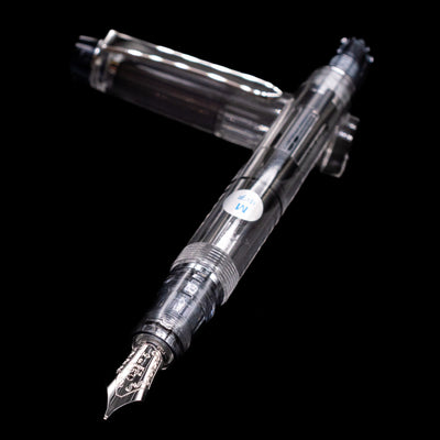 Pilot Custom Heritage 92 Fountain Pen - Clear laying across its own cap, crossed, with a focus on the nib.