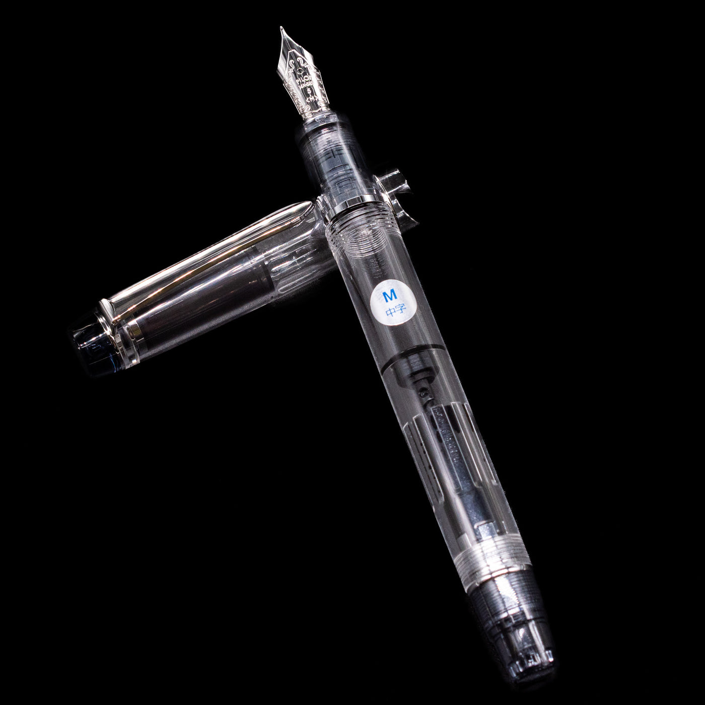 Pilot Custom Heritage 92 Fountain Pen - Clear laying on top of its cap in a crossed position showing full view of the entire uncapped pen.