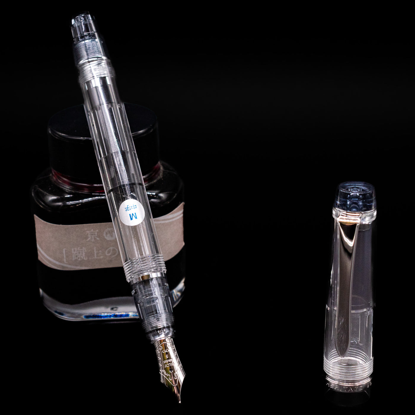 Pilot Custom Heritage 92 Fountain Pen - Clear leaning on an ink bottle uncapped showcasing the detailing on the nib.