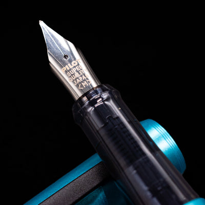 A macro shot of the nib with its intricate detailing and logo engraving for the Pilot Explorer Turquoise Blue Metal Fountain Pen.