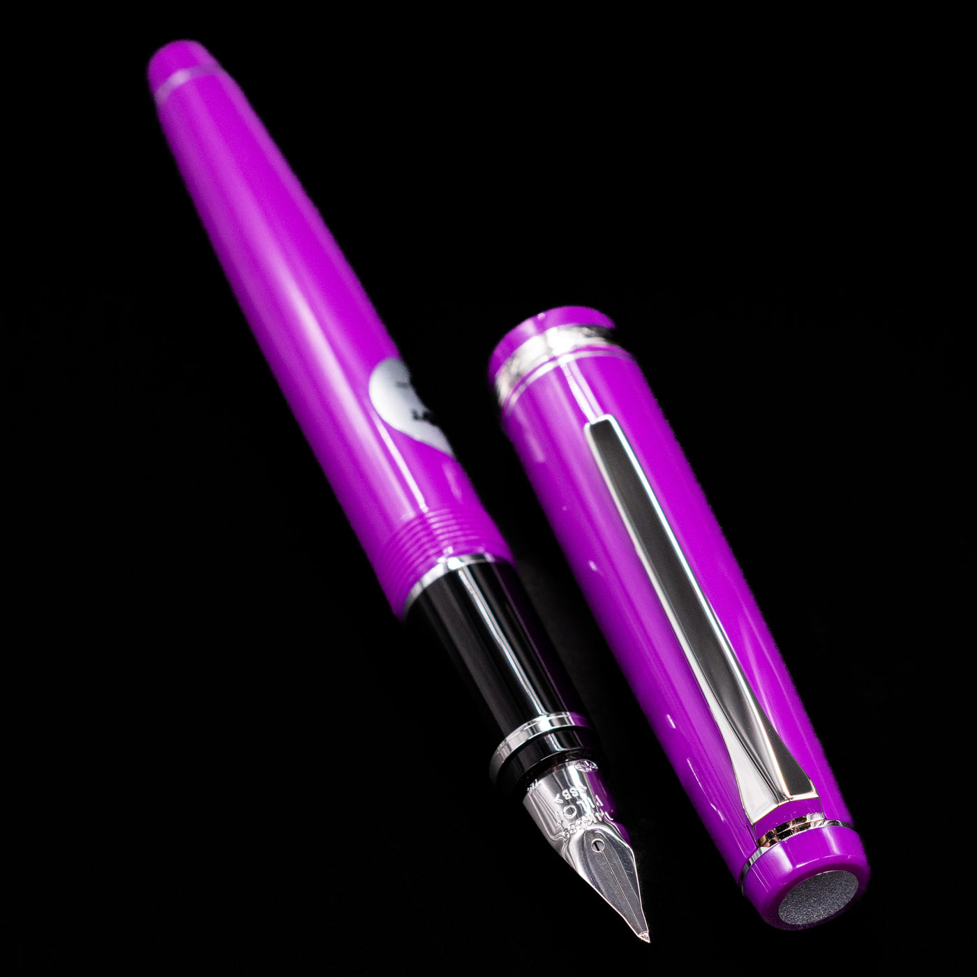  A full view of the Pilot Falcon Fountain Pen - Purple uncapped, with its cap laying next to the pen. 