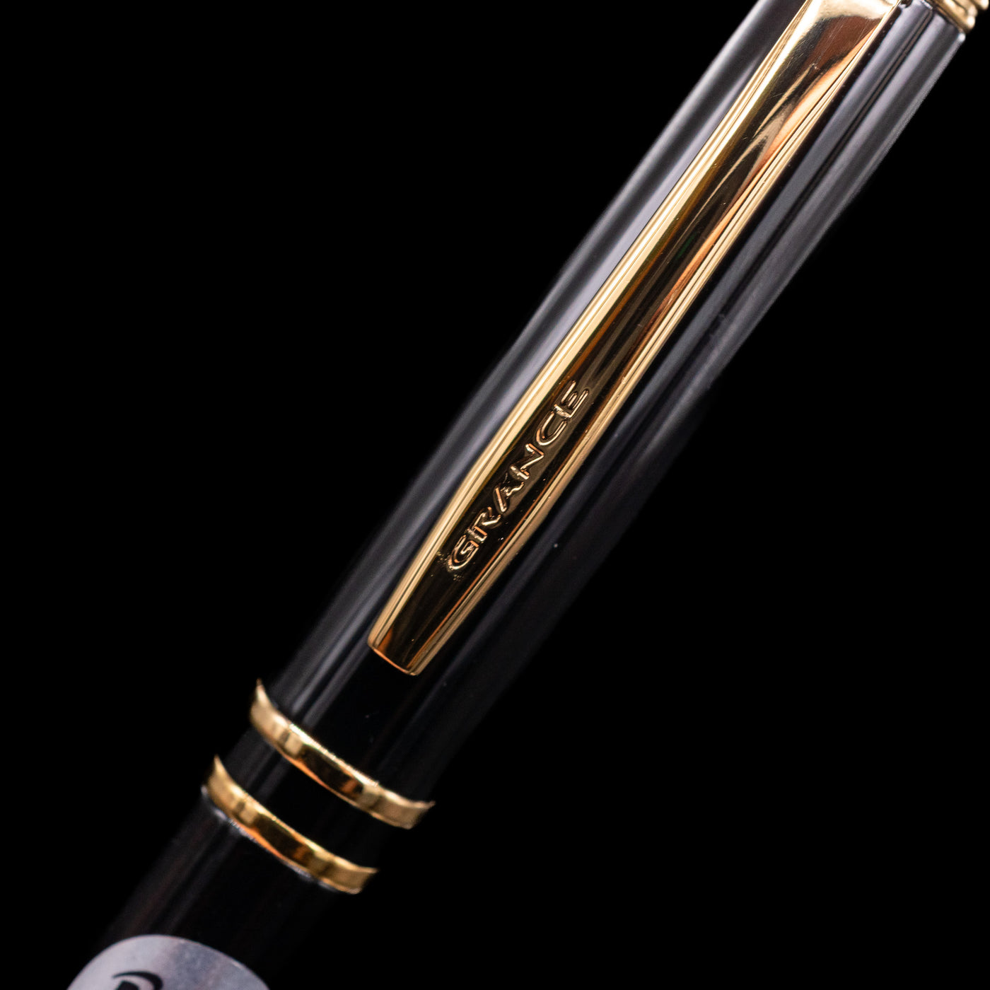 A close-up shot of the clip of the Pilot Grance Fountain Pen - Black with the "grance" lettering.