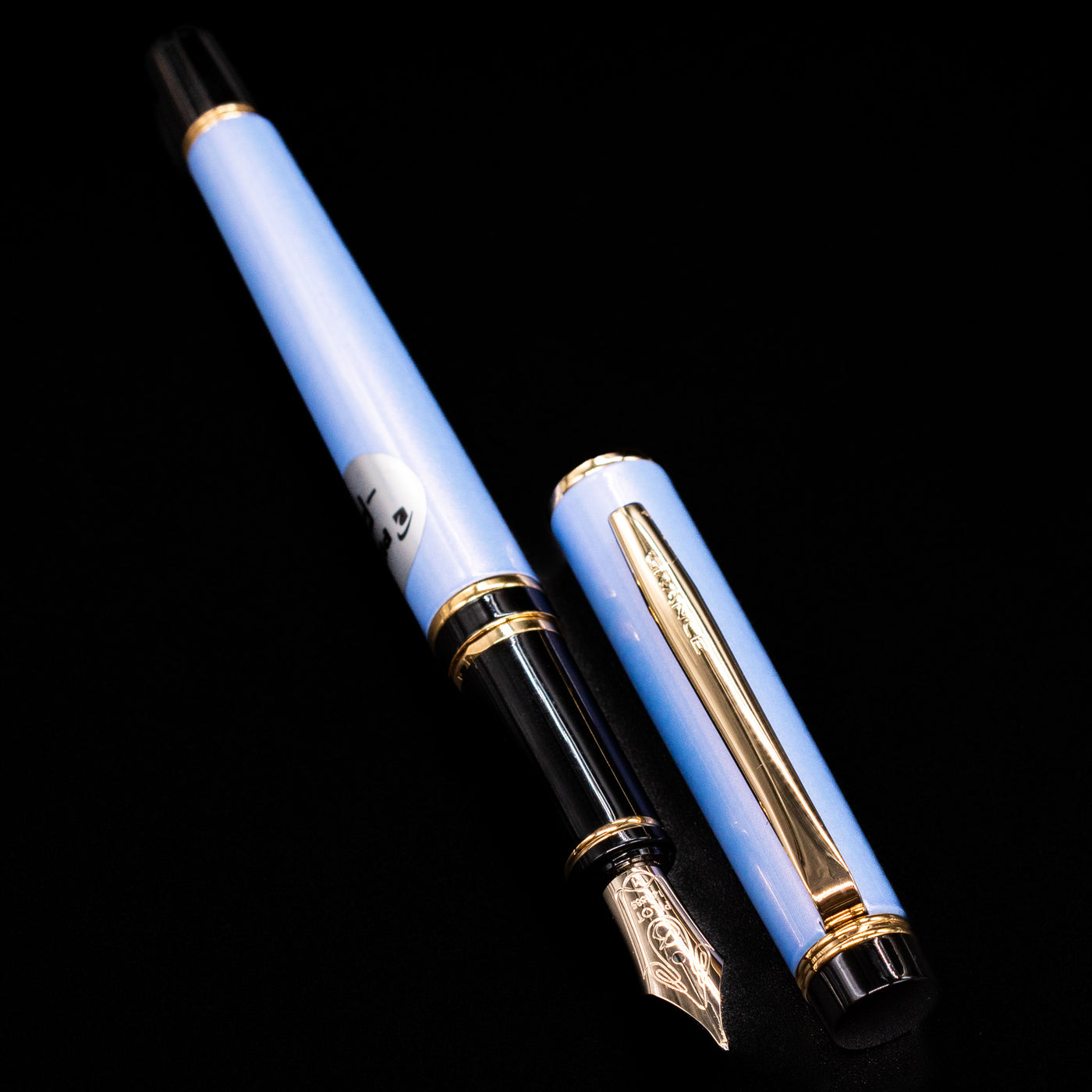  A full view of the Pilot Grance Fountain Pen - Light Blue uncapped, with its cap laying next to the pen. 