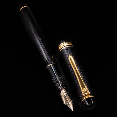 Preowned Pilot Justus 95 Net Black fountain pen displayed uncapped, revealing its gold nib and black net-pattern barrel with polished gold accents.