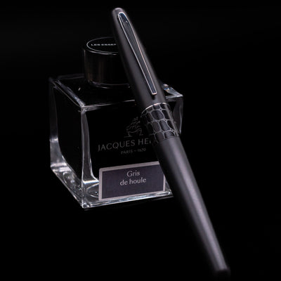 Pilot Metropolitan Fountain Pen - Crocodile capped, leaning against an ink bottle. 
