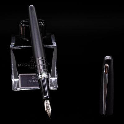 Pilot Metropolitan Fountain Pen - Crocodile leaning on an ink bottle uncapped showcasing the detailing on the nib.