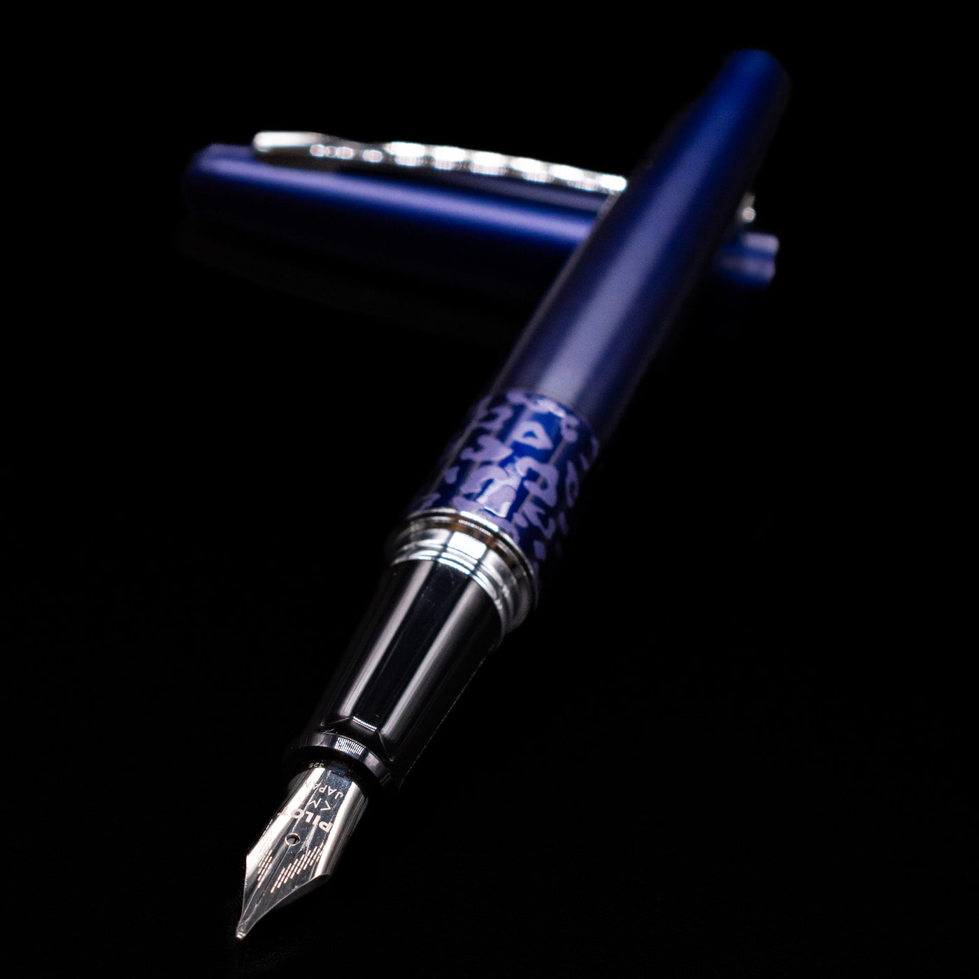 Pilot Metropolitan Fountain Pen - Leopard laying across its own cap, crossed, with a focus on the nib.