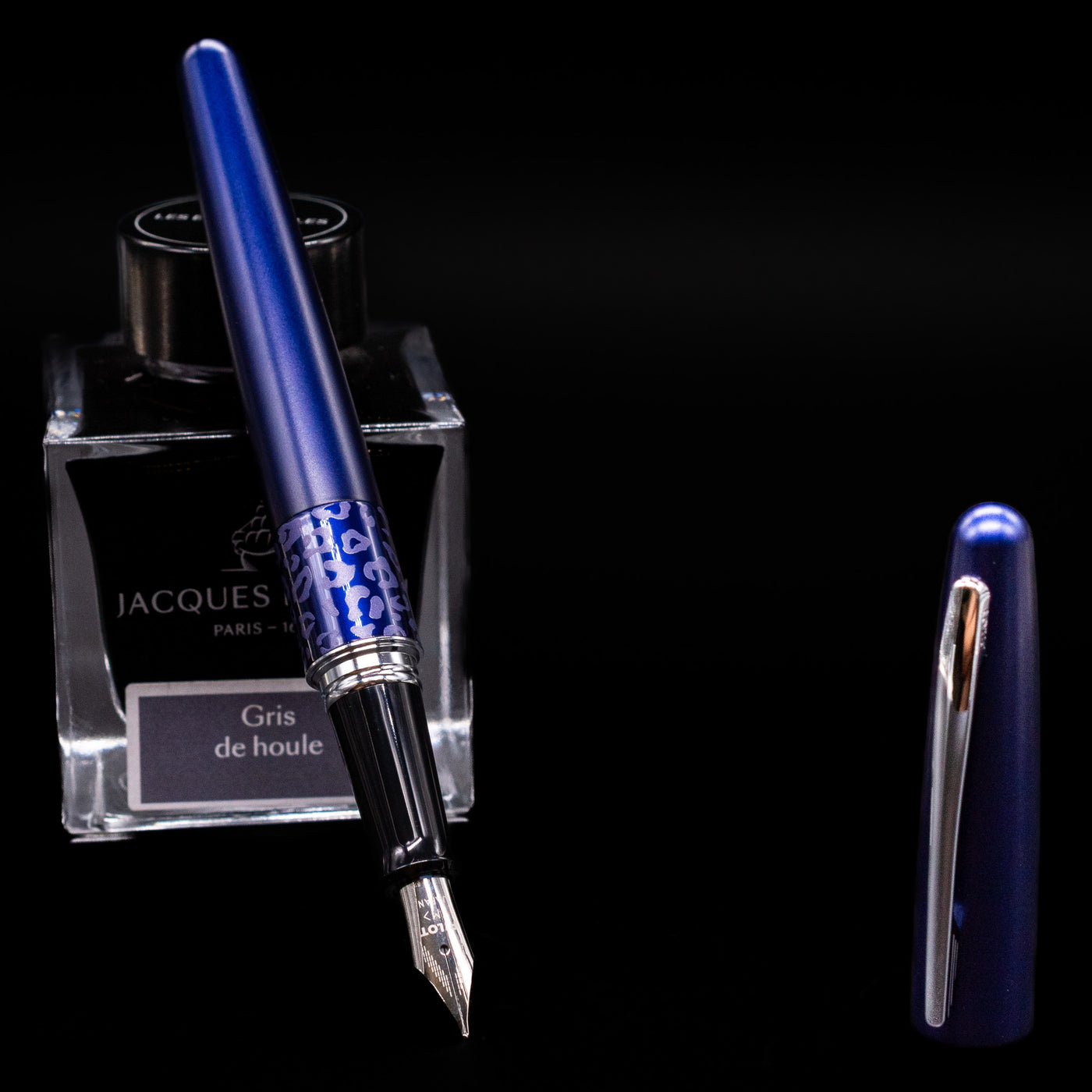 Pilot Metropolitan Fountain Pen - Leopard leaning on an ink bottle uncapped showcasing the detailing on the nib.