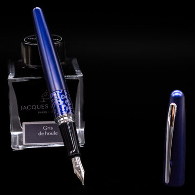 Pilot Metropolitan Fountain Pen - Leopard leaning on an ink bottle uncapped showcasing the detailing on the nib.