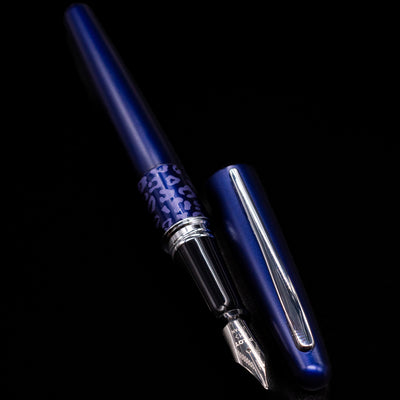 A full view of the Pilot Metropolitan Fountain Pen - Leopard uncapped, with its cap laying next to the pen. 