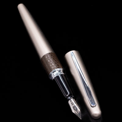 A full view of the Pilot Metropolitan Fountain Pen - Lizard uncapped, with its cap laying next to the pen. 